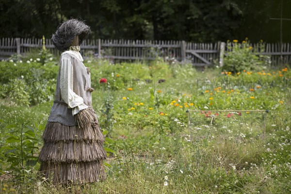 Scarecrow made of straw standing in a garden