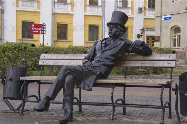 Bronze sculpture of a man with a top hat