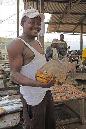 Fisherman hoding a big fish in the fishing port