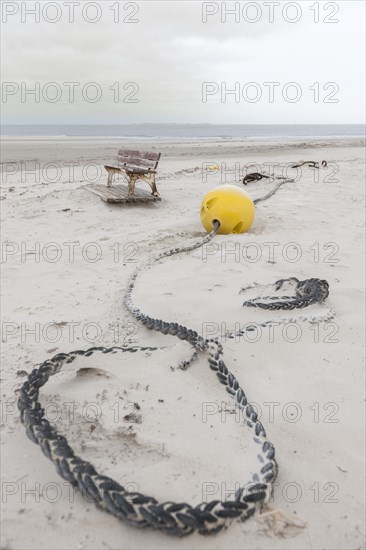 Buoy and a bench on the beach