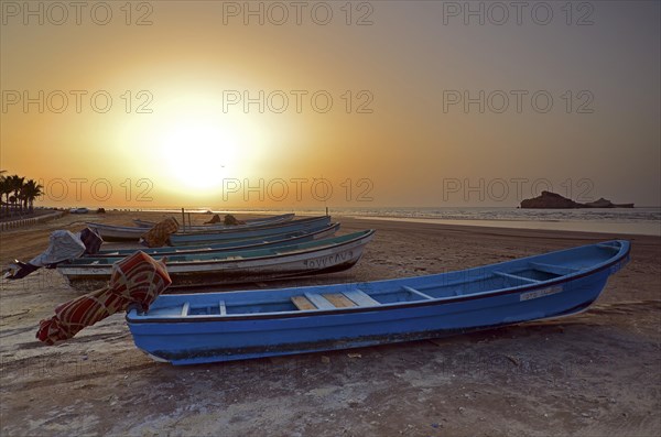 Sunset in Al Sawadi behind a couple of fishing boats