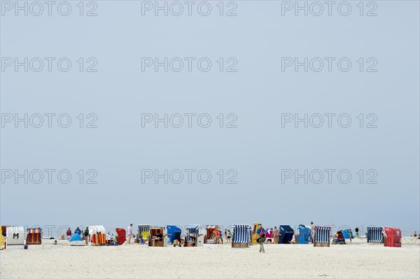 Colourful roofed wicker beach chairs on the beach