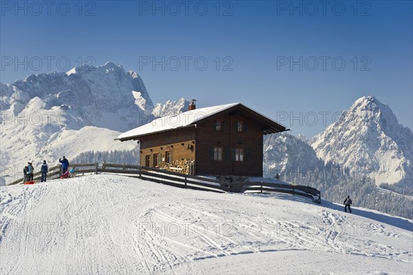 Wooden house on a snow-covered hill, Mt Alpspitze