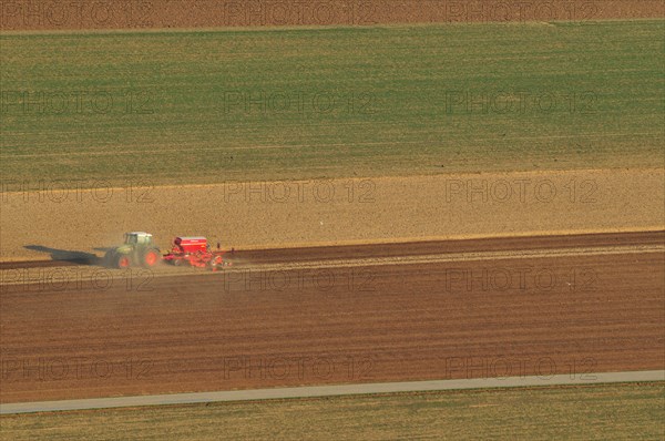 Tractor plowing fields in spring