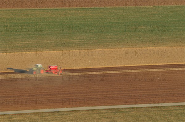 Tractor plowing fields in spring