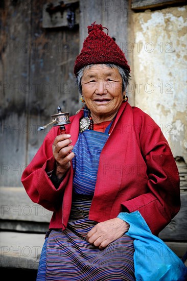 Woman holding a prayer wheel
