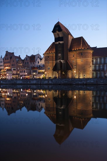 Crane Gate or Brama Zuraw in the historic row of houses at dusk