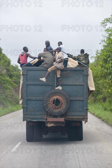 Men getting a lift on a lorry