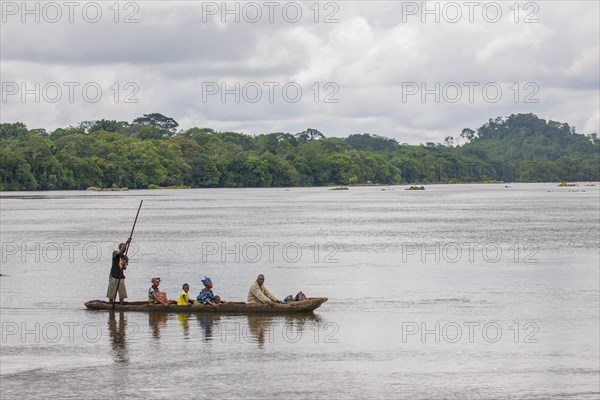 Ferryman taking passengers across the Moa River in a pirogue
