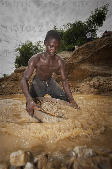 Worker washing gravel at a diamond mine