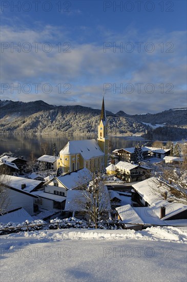 Lake Schliersee with the Church of St. Sixtus in winter