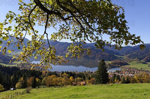 Lake Schliersee and the Parish Church of St. Sixtus as seen from Schliersberg mountain in autumn