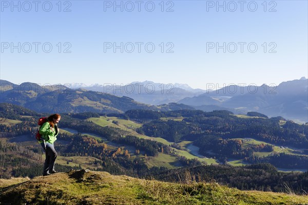 Hiker with views from Kranzhorn mountain towards the Loferer Steinberge mountains and Zahmer Kaiser mountain