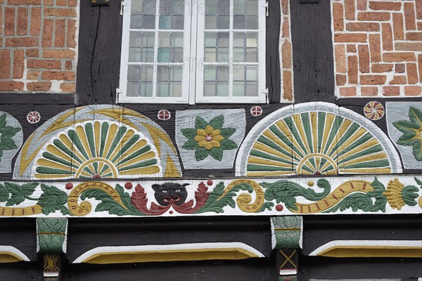 Half-timbered house with painted fan rosettes