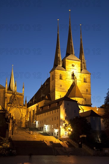 The illuminated St. Severi Church at dusk