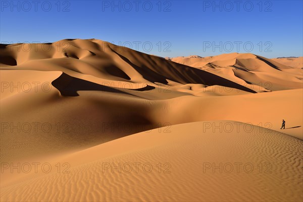 Person walking on a sand dune