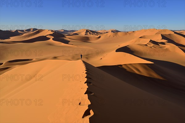 Person walking on a sand dune