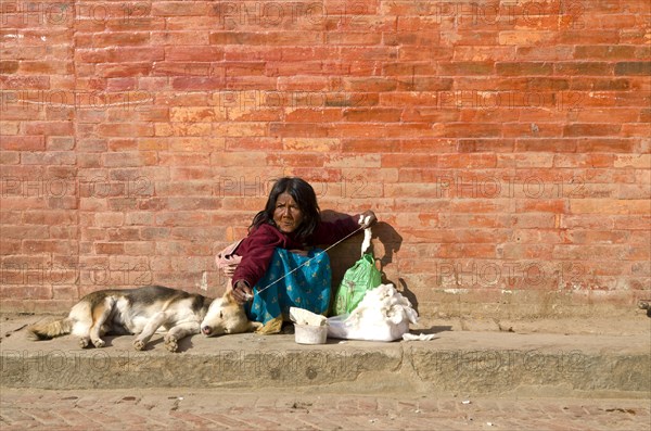 Old woman spinning thread on Durbar Square