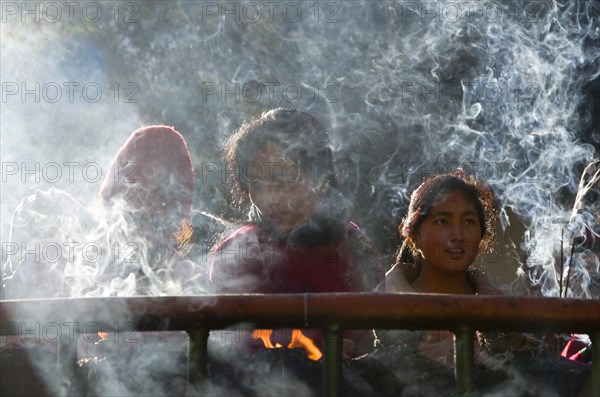Pilgrims burning incense as an offering