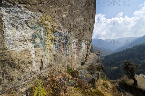 Om mani padme hum mantra painted at a big rock