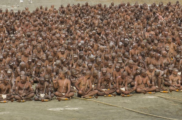 Taking their first meal in the new live as part of the initiation of new sadhus at the Sangam