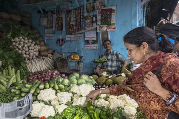 Local woman buying cauliflower at the market