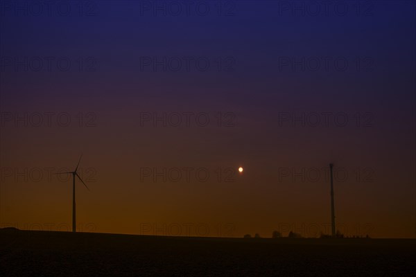 Wind turbines at full moon