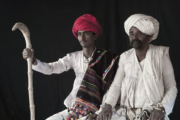 Young and old Rabari tribe men with walking stick