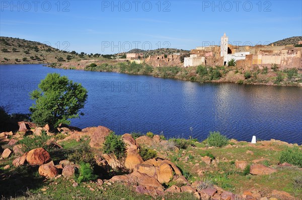 Small village with a mosque and a reservoir