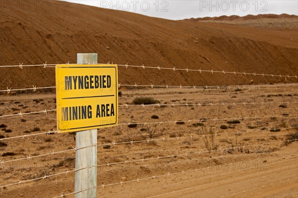 Warning sign on a barbed wire fence