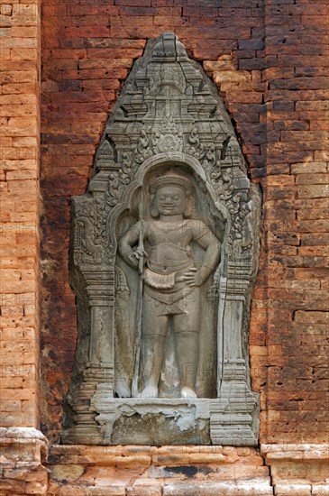 Bas-relief of a male guardian figure holding a trident-spear in his hand