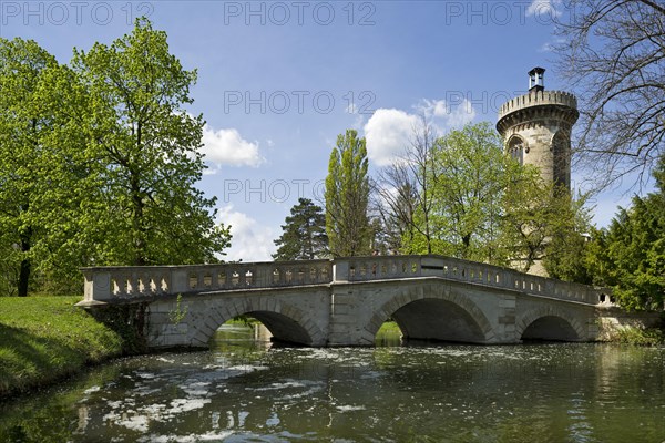 Castle pond with a stone bridge in the gardens of Schlosspark Laxenburg