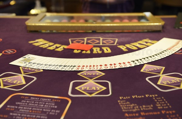 Poker table with a deck  of poker cards