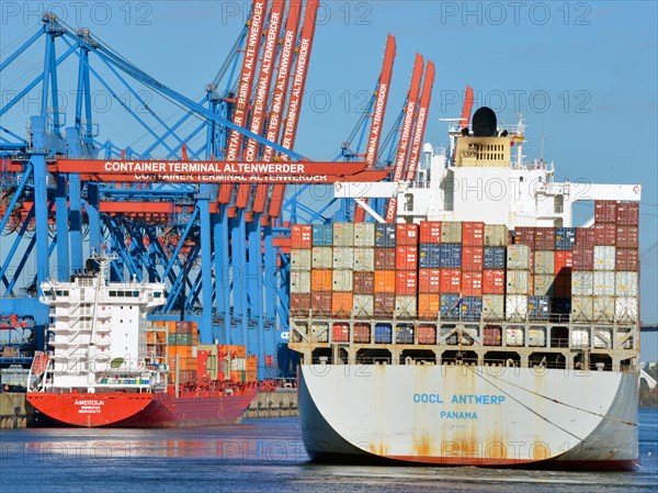 Container ship OOCL Antwerp with a feeder ship