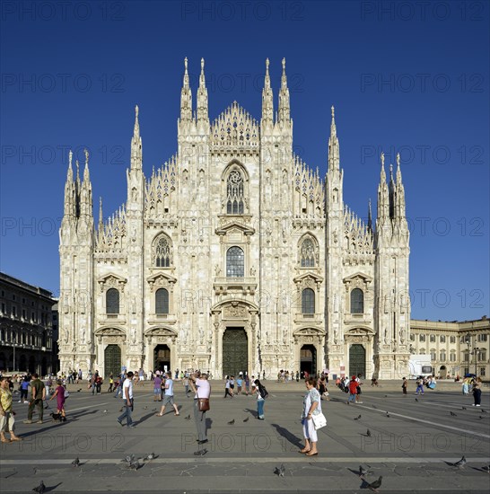 Tourists in front of the west facade of Milan Cathedral or Duomo di Santa Maria Nascente