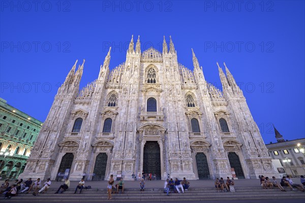 Tourists in front of the west facade of Milan Cathedral or Duomo di Santa Maria Nascente