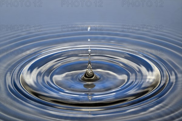 Water droplets falling onto water surface