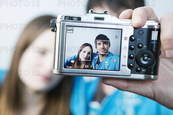 Couple taking pictures of themselves