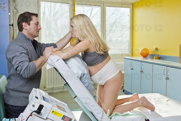 Man and woman in the delivery room during childbirth