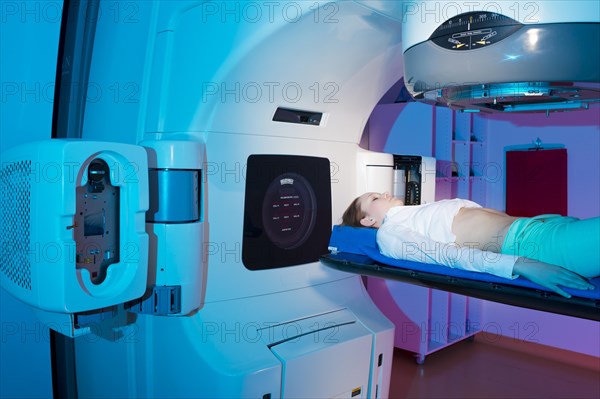 Patient lying in a linear particle accelerator for radiation treatment