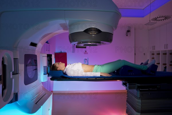 Patient lying in a linear particle accelerator for radiation treatment