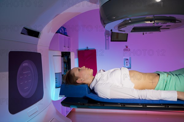 Patient lying in a linear particle accelerator for radiation treatment