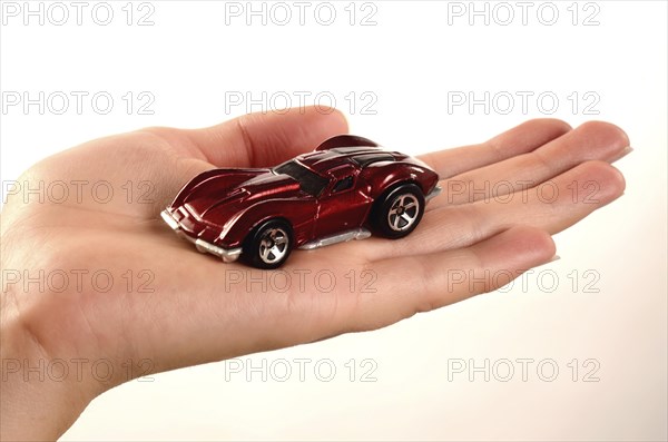 Hand holding a miniature car