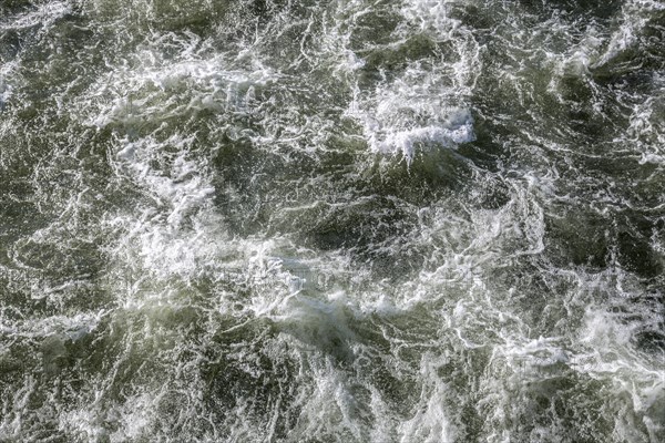 Rough waters of a river swirling after emerging from a barrage