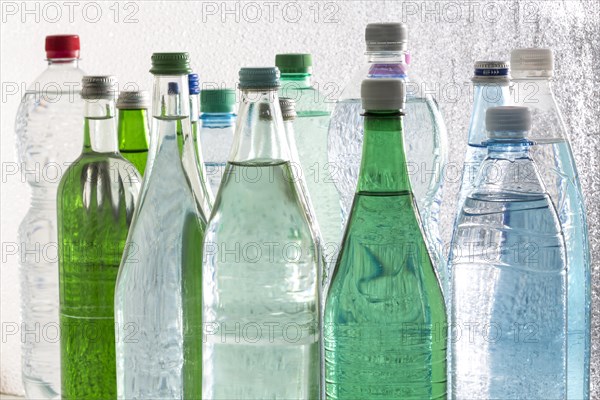 Different varieties of mineral water in bottles made of glass and plastic or PET