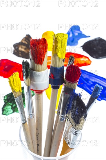 Different types of brushes with colourful acrylic paints