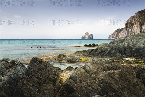 Spiaggia di Masua bay with the Pan di Zuccherof ??rock island in the sea