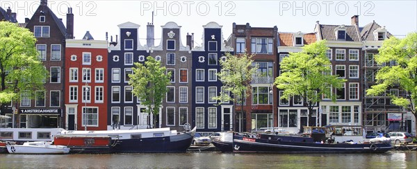 Typical canal houses and boats along the Amstel Canal