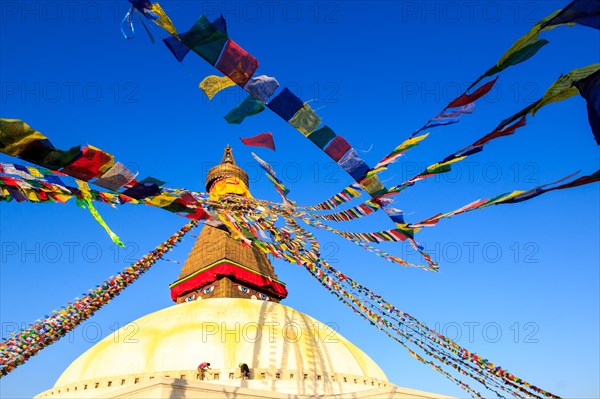 Two men are painting the Boudhanath stupa