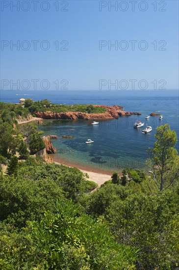 Calanque bay with boats at Cap Roux in the Esterel mountains